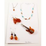 Baltic amber brooch in the form of a guitar, two pairs of ear-rings,