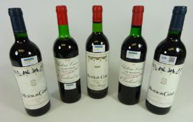 Three bottles of Mouton Cadet red wine;
