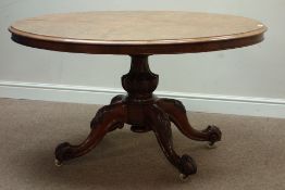 Victorian walnut loo table, oval tilt top, carved baluster column, four splayed legs, 136cm x 105cm,