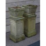 Pair of square garden planters on pedestals,