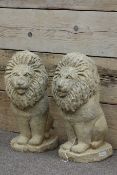 Pair composite stone seated lions,