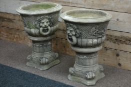 Pair composite stone garden urns on plinths with lion motif, D54cm,