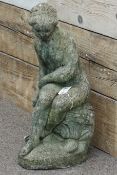 Composite stone garden figure of a seated maiden,