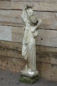 Classical style composite stone figure of a woman carrying an urn,