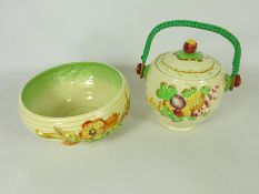 Clarice Cliff bowl moulded with blossom and a similar biscuit barrel decorated with fruit by A.J.