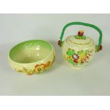 Clarice Cliff bowl moulded with blossom and a similar biscuit barrel decorated with fruit by A.J.