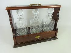Mahogany and brass Tantalus with three cut glass decanters Condition Report <a