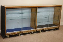 Double light oak and glazed illuminated shops display cabinet enclosed by sliding glass doors,