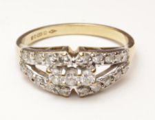 Gold ring set with three central diamonds and ten further diamonds to either side hallmarked 9ct