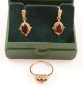 Three stone garnet ring hallmarked 9ct and a similar pair of ear-rings Condition Report
