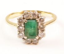 Emerald and diamond cluster ring hallmarked 18ct Condition Report <a