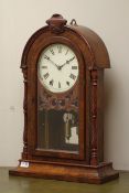 19th century figured walnut mantel clock, arched form with carved pediment,