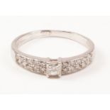 Hallmarked 18ct white gold ring set with princess cut central diamond and twenty further diamonds