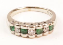 Emerald and diamond channel set white gold ring stamped 14kt Condition Report