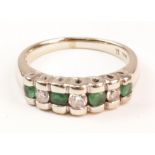 Emerald and diamond channel set white gold ring stamped 14kt Condition Report