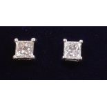 Pair of white gold princess cut diamond stud ear-rings stamped 750 Condition Report