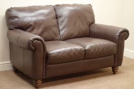 'Italsofa' two seat sofa upholstered in brown leather, turned walnut finish feet,