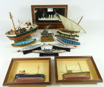 Wooden model of a trawler, two Whitby cobbles, three diecast naval ship models,