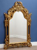 Wall mirror in floral gilt frame with shaped top, W90cm,