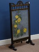 Early 20th century black painted and gilt firescreen with mottled glass panel, painted with flowers,