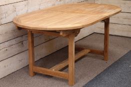 Solid teak extending garden table with foldout leaf,