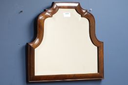 Late 19th century walnut framed mirror, shaped bevelled glass plate,
