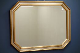 Gilt framed wall mirror with canted corners, bevelled glass plate,
