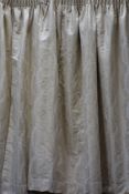 Pair lined pleated curtains in pale gold fabric, with pull backs, W285cm,