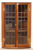 Early 20th century mahogany bow front corner cabinet, two lead glazed doors, W69cm,