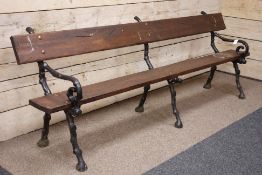 Large garden bench with polished rustic pine seat and back and cast iron branch effect supports