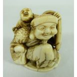 Meiji period ivory Netsuke of a man carrying child and another at his feet, with signature on base,