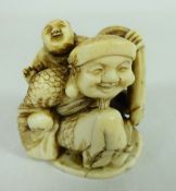 Meiji period ivory Netsuke of a man carrying child and another at his feet, with signature on base,