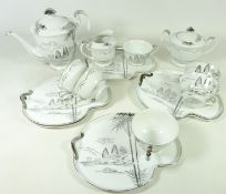 Japanese Kutani China tea service, decorated with landscapes in silver on a white ground,