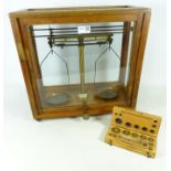 Cased set of Chemical Balance scales and a boxed set of brass metric weights (2)