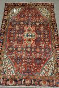 Persian Bijar red ground rug, decorated with heratti motifs,