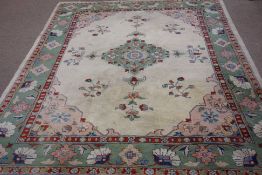 Persian design beige ground rug carpet, green boarder and central medallion,