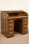 Early 20th century oak tambour roll top desk, eight drawers and two slides, well fitted interior,