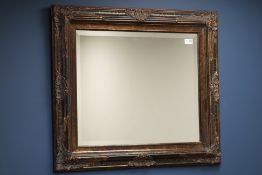 Ornate black lacquered and gilt bevelled edge wall mirror (82cm x 73cm),