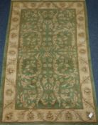Large green ground Indian wool rug,