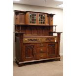 Arts and Crafts period oak sideboard, the base fitted with five drawers and two cupboards,
