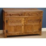 Mid 20th century carved oak sideboard fitted with two drawers and two cupboards,