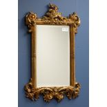 Ornate gilt framed mirror with bevelled glass plate,