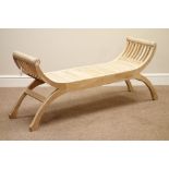 Curved x-framed solid teak bench,