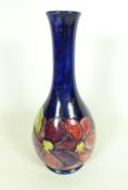 Moorcroft Clematis pattern bottle vase with impressed marks and signature to base,