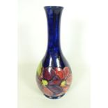 Moorcroft Clematis pattern bottle vase with impressed marks and signature to base,