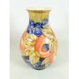 Old Tupton Ware Moorcroft style vase with berry and pomegranate tubeline decoration, H29.