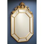 Octagonal wall mirror in gilt frame with sectional mirrored border and ornate pediment, W89cm,