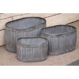 Three galvanized metal oval graduating dolly tub type planters,