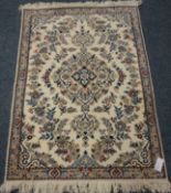 Small Persian Nain cream ground rug with blue floral decoration,