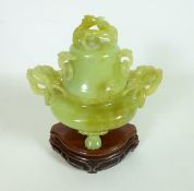 20th Century Chinese carved jade Koro with dragon handles and finial on carved wood stand,